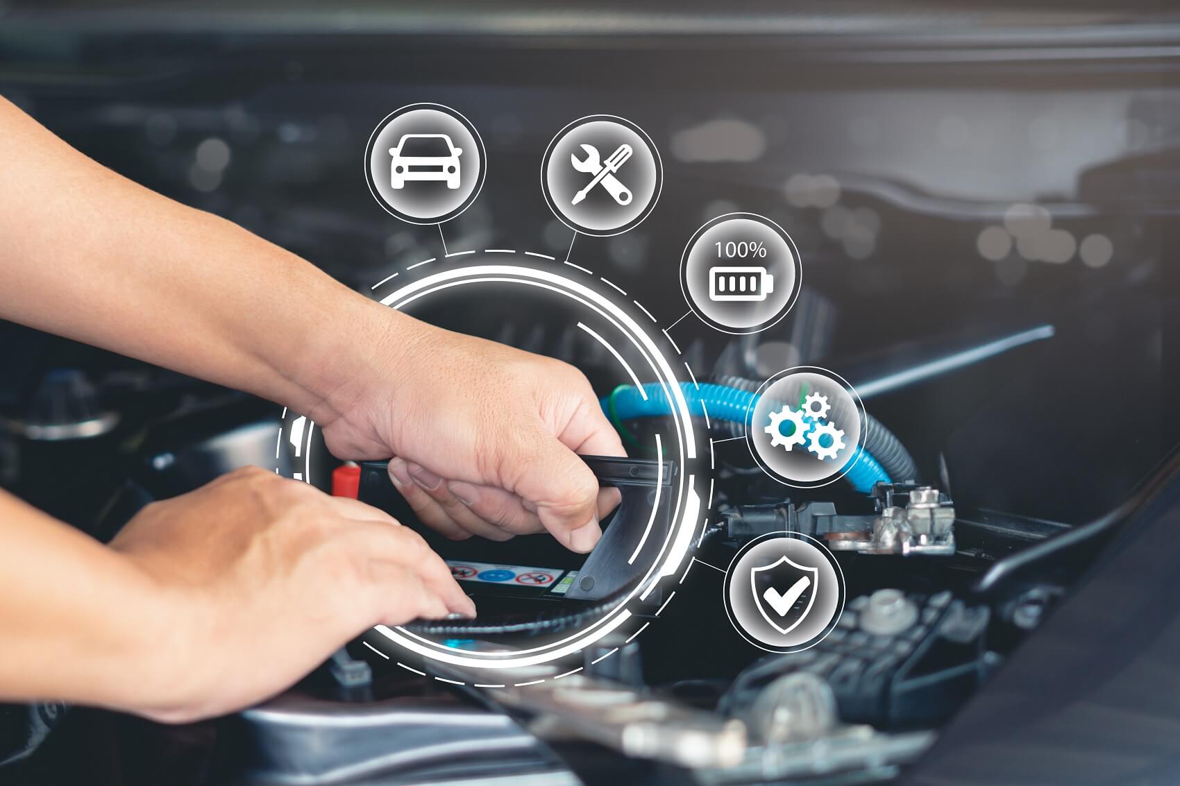 Mechanic hands working on car with service symbols around it